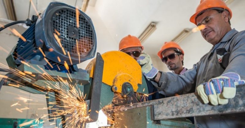 three workers cutting