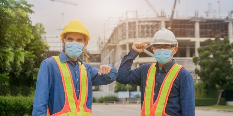 workers touching their elbows